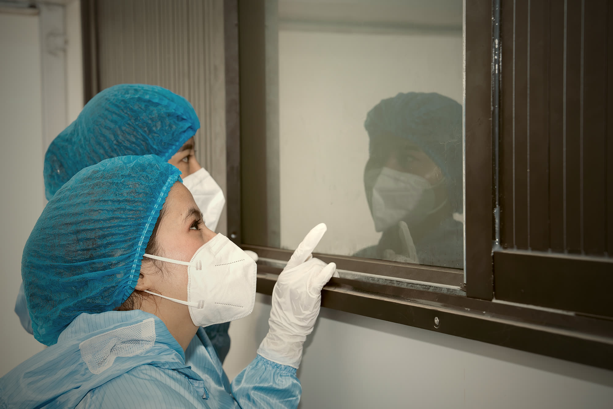 NIS NEST staff in protective clothing observing the swiftlets' living habitat