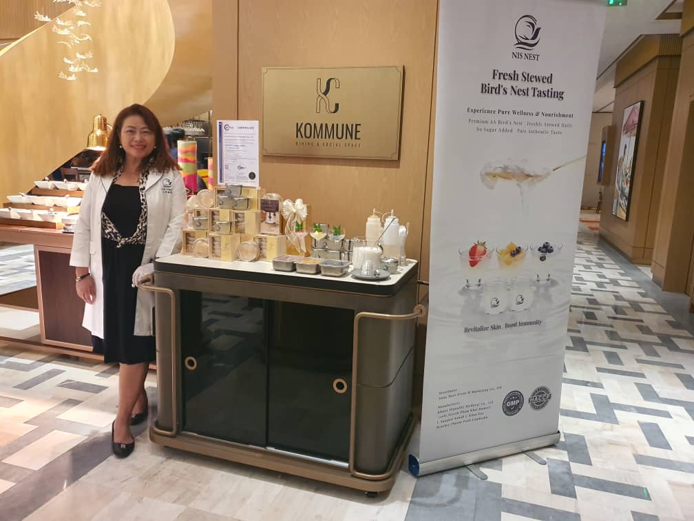 NIS NEST host with tasting cart and banner