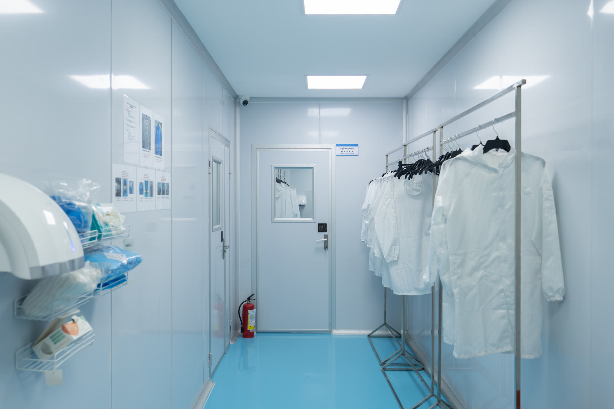 Hygiene corridor at the NIS NEST factory, Cambodia, with protective gowns and controlled access